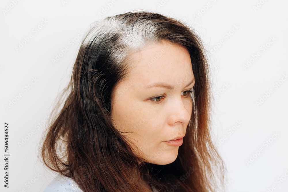 Girl with dry shampoo on the roots of dark fluffy hair. Girl with dry shampoo on the roots of dark fluffy hair.