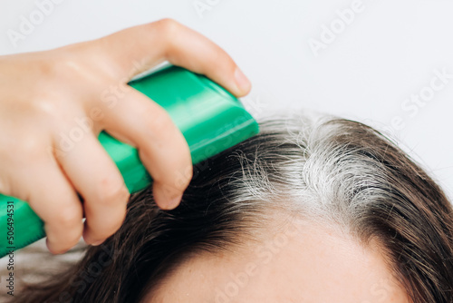 Wallpaper Mural Girl applying dry shampoo spray on roots of dark fluffy hair. Torontodigital.ca