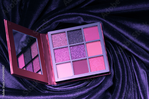Fotografie Velvet Violet eyeshadow palette on the background of luxurious velor fabric