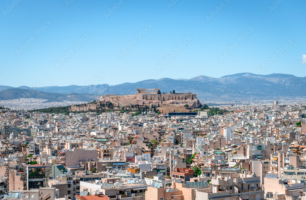 The Athens skyline, seen from Kynosargous Hill. The Acropolis Hill with the Parthenon and the Odeon of Herodes Atticus dominates the picture.