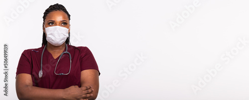 African american doctor in a medical mask over white banner background with copy space. Medicine, healthcare and people concept.