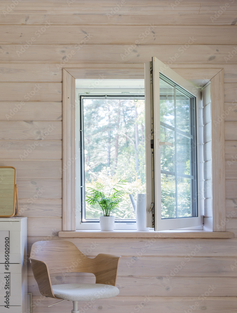 Fototapeta premium White window with mosuito net in a rustic wooden house