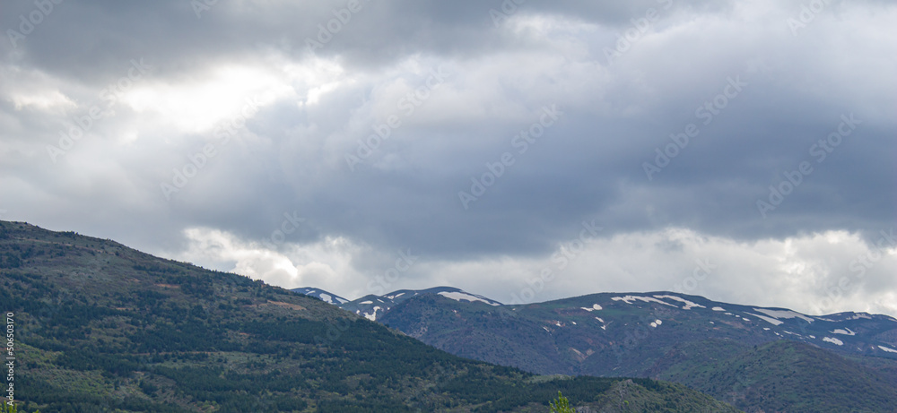 Mountain landscape with cloudy sky.