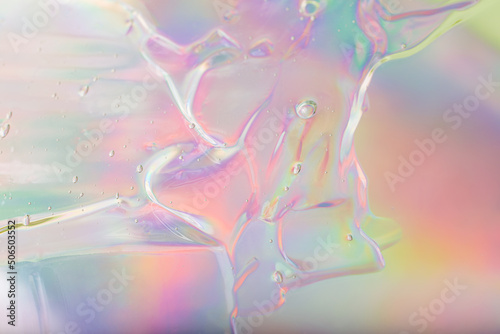 Abstract cosmetics gel on holographic background.Good as cosmetic banner.