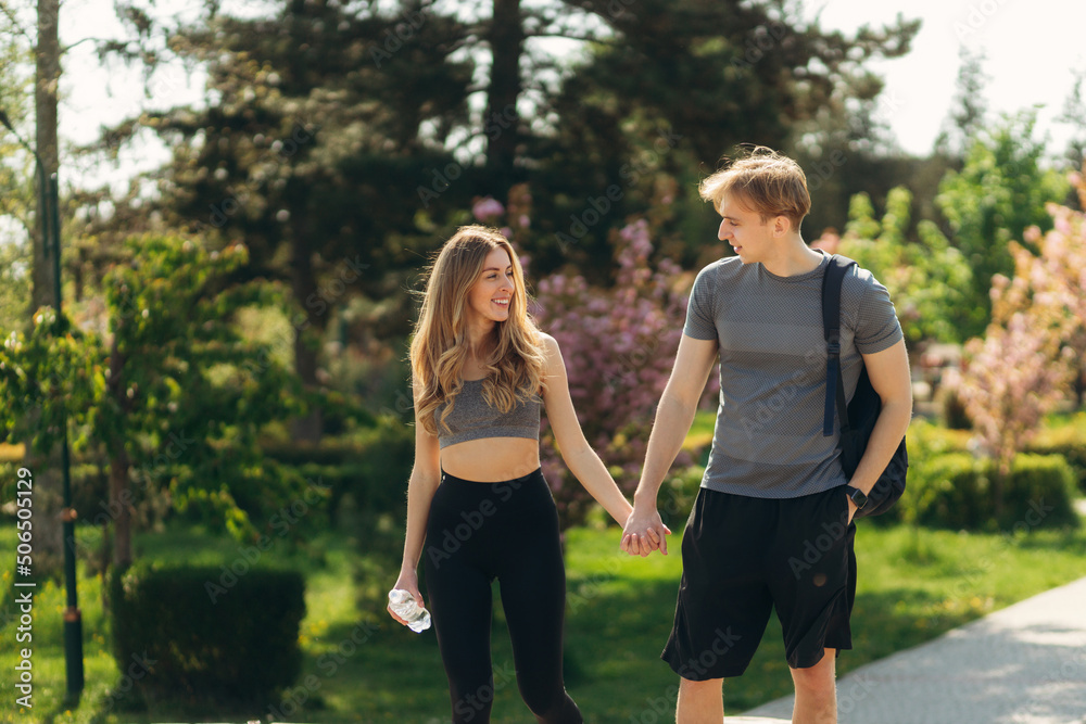 Athletic couple communicate after training. Summer. Healthy lifestyle concept