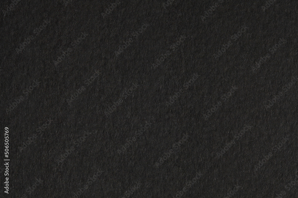Black paper grain texture background.