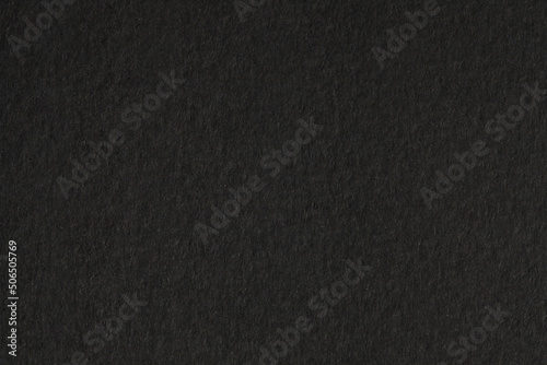 Black paper grain texture background.