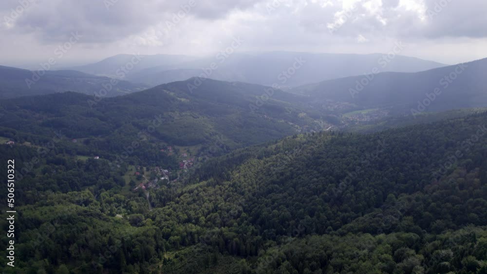 Mountains and forests in the vicinity of Bielsko-Biala. Sunny weather and green trees. The road in the middle of the forest. Mountains and forests in the vicinity of Bielsko-Biala. Sunny weather and green trees. The road in the middle of the forest.