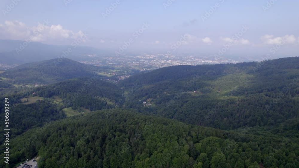 Mountains and forests in the vicinity of Bielsko-Biala. Sunny weather and green trees. The road in the middle of the forest. Mountains and forests in the vicinity of Bielsko-Biala. Sunny weather and green trees. The road in the middle of the forest.