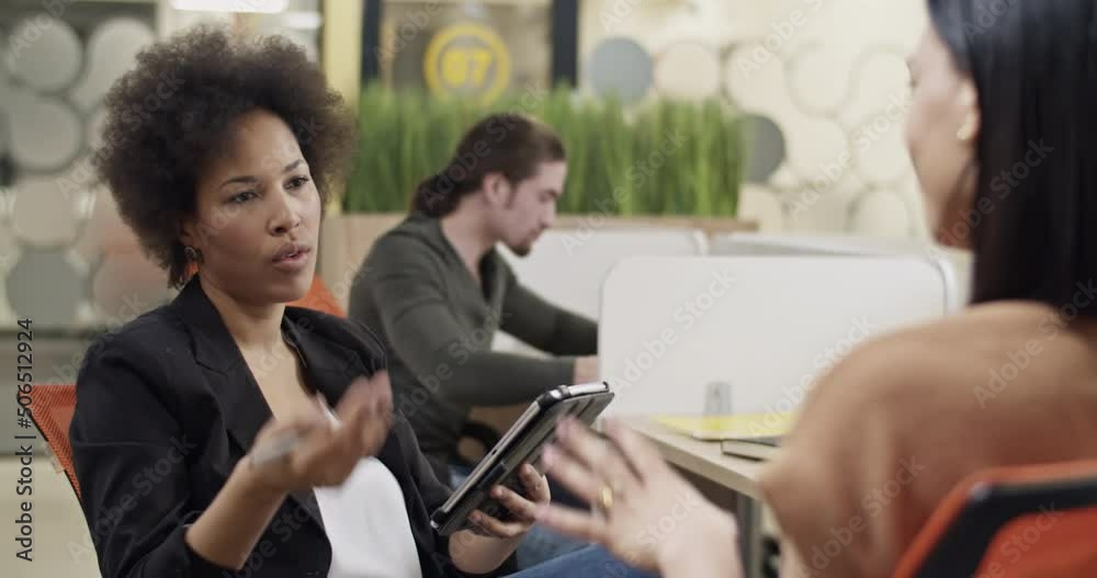 Black HR manager speaking with employee Black HR manager speaking with employee