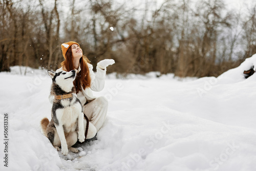 Fototapeta Naklejka Na Ścianę i Meble -  woman with a purebred dog winter walk outdoors friendship winter holidays