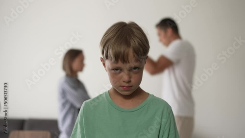 Kid son feels upset while parents fighting at background, sad little girl frustrated with psychological problem caused by mom and dad arguing, family conflicts or divorce impact on child concept