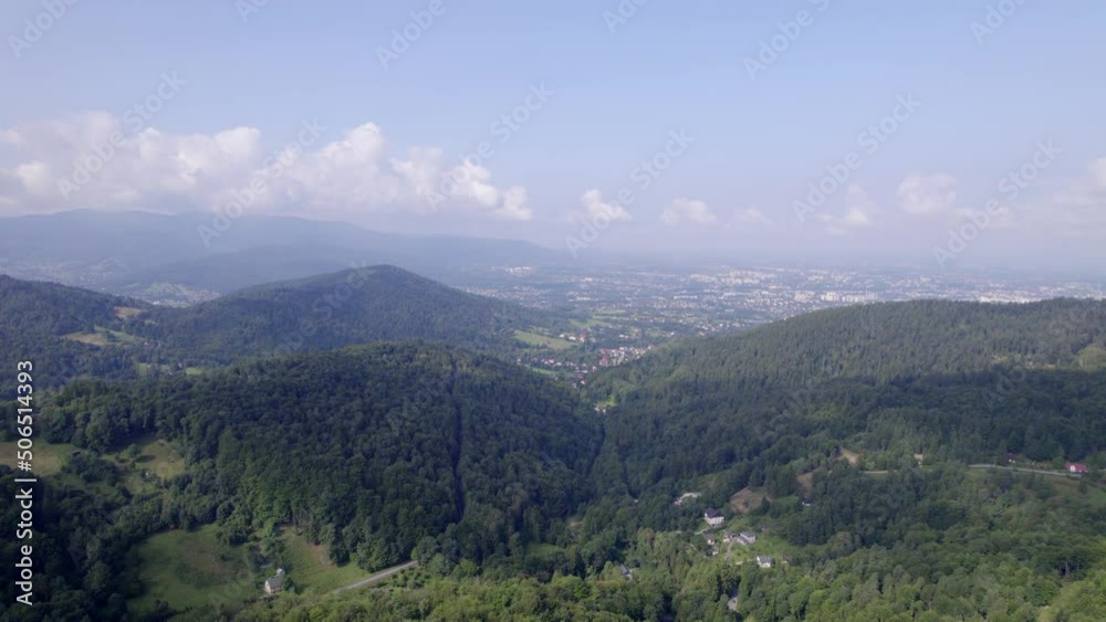 Mountains and forests in the vicinity of Bielsko-Biala. Sunny weather and green trees. The road in the middle of the forest. Mountains and forests in the vicinity of Bielsko-Biala. Sunny weather and green trees. The road in the middle of the forest.