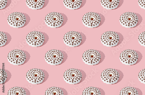 Pattern of donuts on pink pastel background