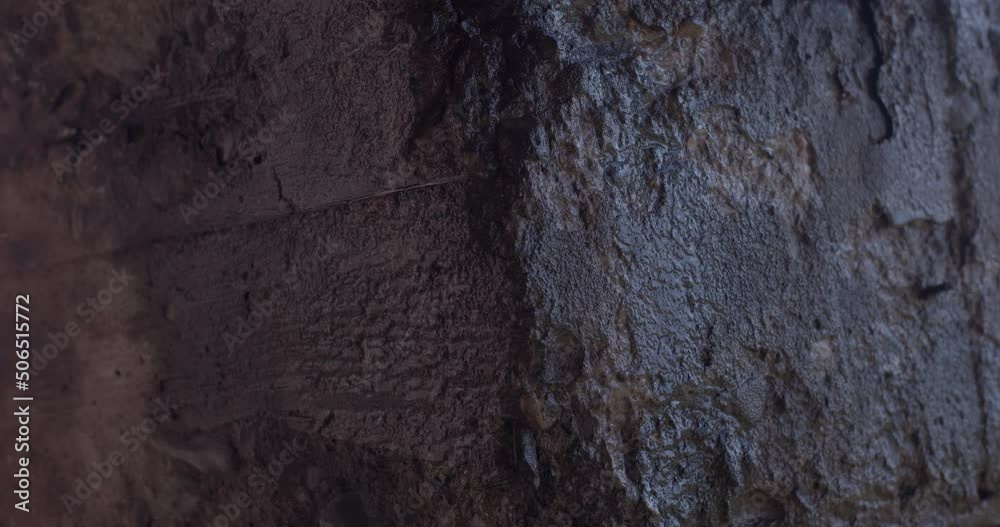 Place of dampness in the basement of the underground floor. Water flows over the surface of a concrete wall. A place of corrosion and mold, naturally the destruction of the building.