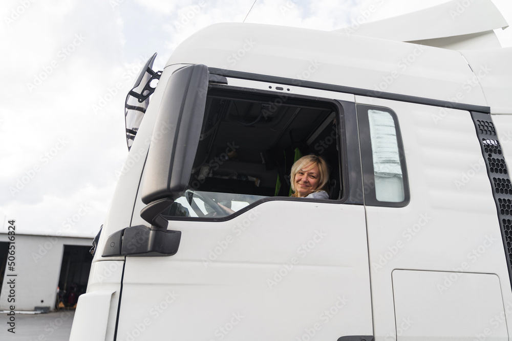 Caucasian mid age woman driving truck. trucker female worker, transport industry occupation Caucasian mid age woman driving truck. trucker female worker, transport industry occupation
