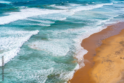 Aerial view of tropical sandy beach and ocean with turquoise water with waves. Sunny day on Atlantic ocean beach