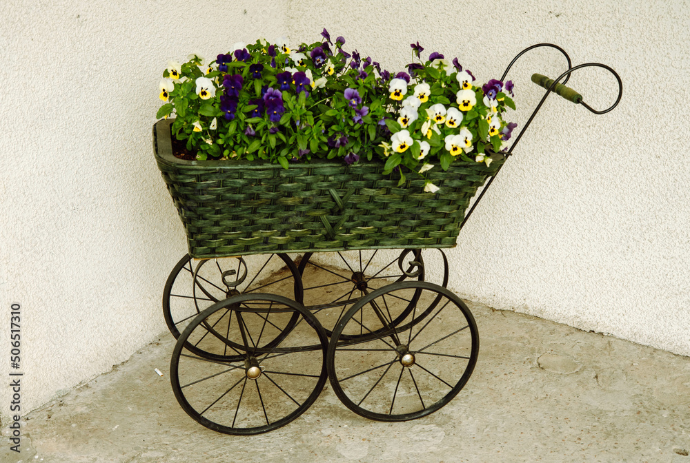 Vintage stroller reused as plant pots holder
