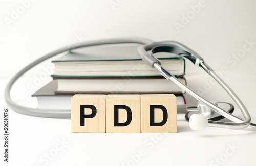PDD - Premenstrual Dysphoric Disorder acronym with wooden cubes photo