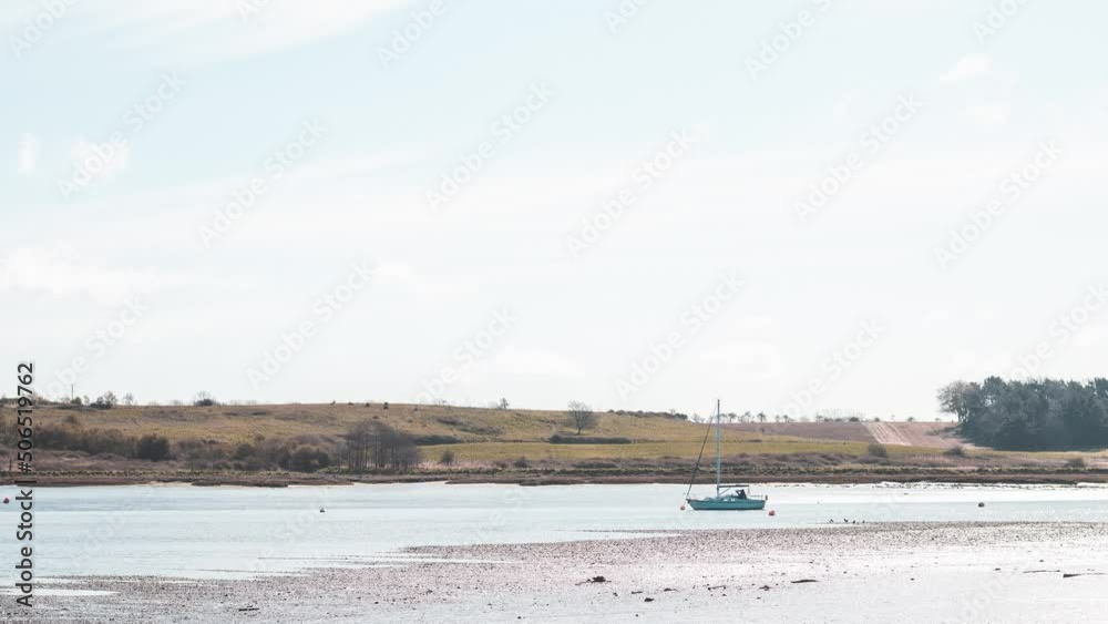 timelapse of river with sailing boat blue sky with clouds and fields in background summer 4K UHD timelapse of river with sailing boat blue sky with clouds and fields in background summer 4K UHD