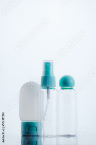 Means for face and body care. A complex of organic care products. Bottles for the transportation of cosmetics traveling by plane. Clean color palette.