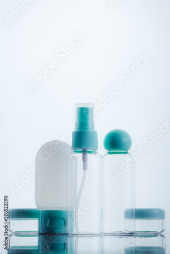 Means for face and body care. A complex of organic care products. Bottles for the transportation of cosmetics traveling by plane. Clean color palette.