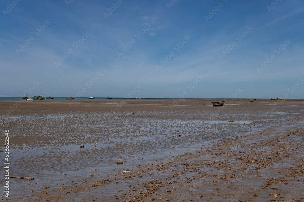 Ocean at low tide showing corals, rocks and small fishing boats in Bahia, Brazil, South America, Atlantic Ocean Ocean at low tide showing corals, rocks and small fishing boats in Bahia, Brazil, South America, Atlantic Ocean