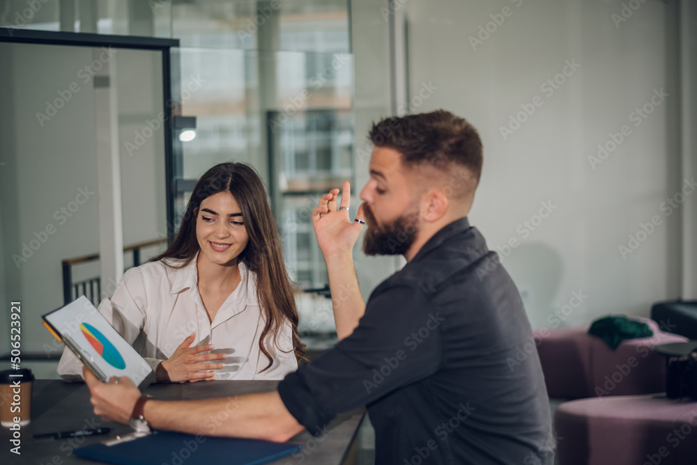 Two business colleagues having a meeting in the open space office Two business colleagues having a meeting in the open space office