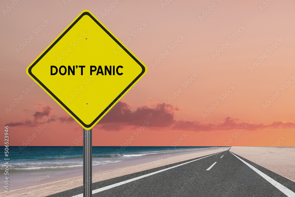 Don't Panic sign on sky background.