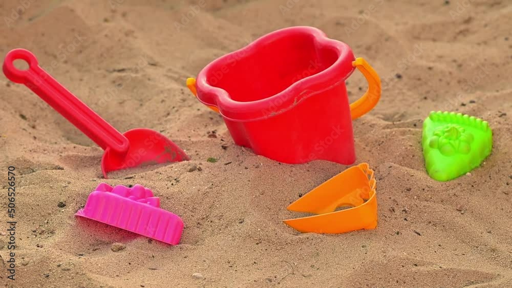 Sandy beach by the sea close-up. Movement along the beach on the sand. Recreation and tourism by the sea or ocean. Children's sand set and toys in the sand. Family holidays with children. FullHD Sandy beach by the sea close-up. Movement along the beach on the sand. Recreation and tourism by the sea or ocean. Children's sand set and toys in the sand. Family holidays with children. FullHD