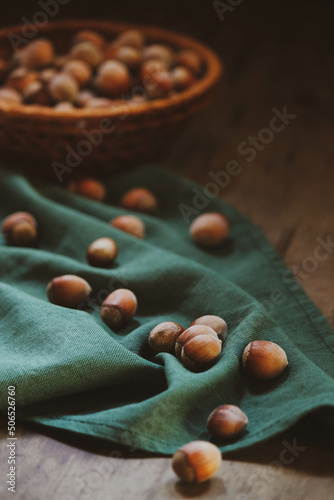 a scattering of hazelnuts on a green cloth