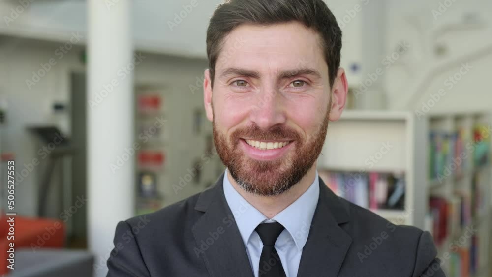 Portrait of an influential, successful, intelligent Caucasian male businessman, company director, top manager, in a modern office, wearing stylish business suit, looking at the camera, smiles friendly Portrait of an influential, successful, intelligent Caucasian male businessman, company director, top manager, in a modern office, wearing stylish business suit, looking at the camera, smiles friendly