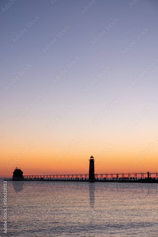 Sunset at the Grand Haven lighthouse and pier on Lake Michigan, Michigan, USA