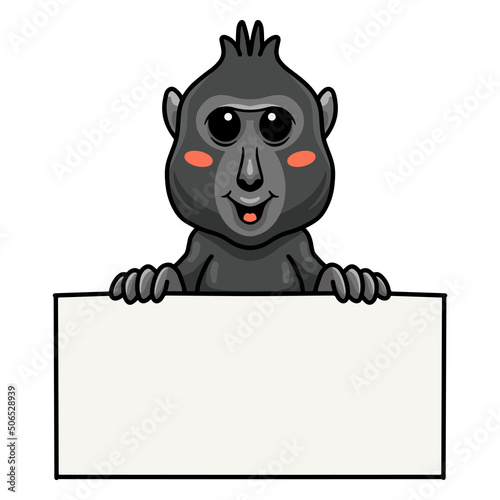 Cute little crested black macaque cartoon with blank sign