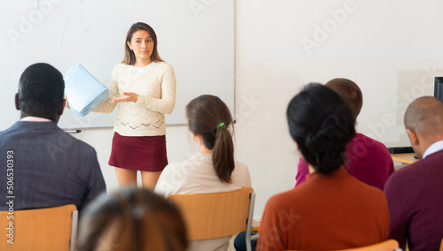 Businesswoman advertises a product in front of an audience