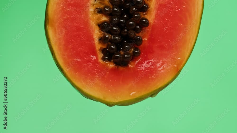 Sweet papaya half isolated on green background chroma key, fresh sliced pawpaw close-up. Tropical fruits. Healthy eating, vegan food. Sweet papaya half isolated on green background chroma key, fresh sliced pawpaw close-up. Tropical fruits. Healthy eating, vegan food.