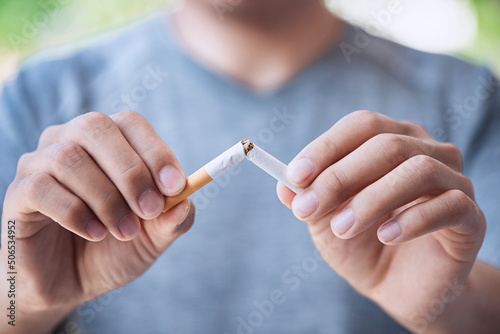 Stop cigarette, man hands breaking the cigarette for good health. photo