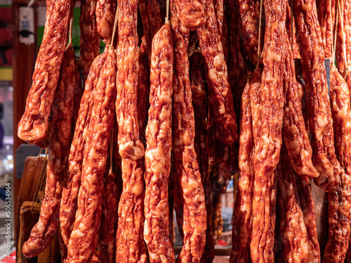 Bacon and sausages hanging in a deli