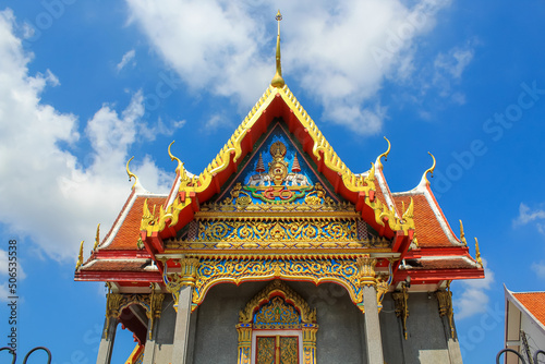 Front view of the Thai buddhist temple in Phuket, Thailand. Blue sky, copy space for text, wallpaper, golden, red, green, blue, horizontal image