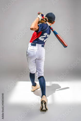 Photography Male youth baseball player swinging his bat and hitting a home run