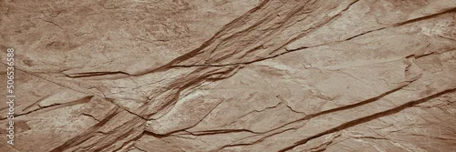Panel kuchenny z motywem   Light brown rock texture. Rough mountain surface. Close-up. Beige stone background with space for design. Web banner. Wide. Panoramic. Sandstone. Solid, rocky, slate.      
