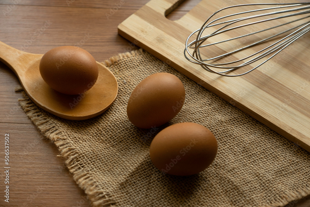 Fresh and raw chicken eggs on a wooden background. Fresh and raw chicken eggs on a wooden background.