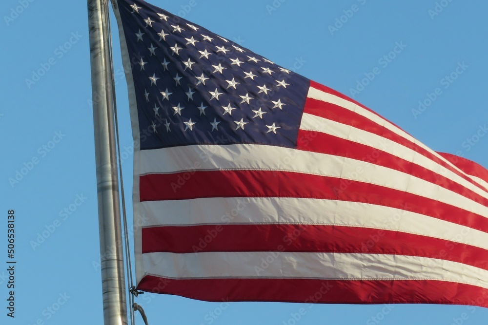 American flag on blue sky background