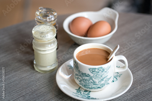 Canvas Print Coffee with boiled eggs, soy sauce and white pepper on table