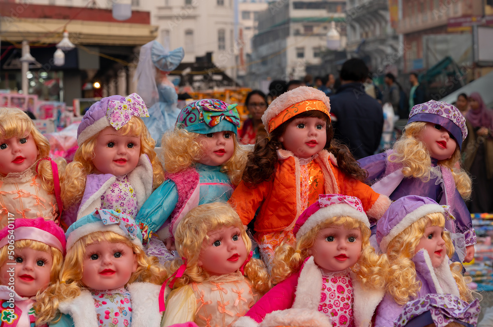 Fototapeta premium Beautiful cute baby girl dolls for sale at retail shop at Christmas market, New Market area, Kolkata, West Bengal, India.