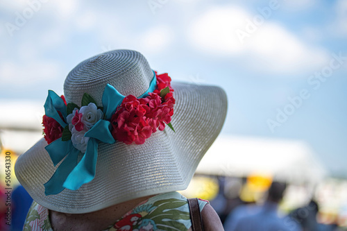 Vászonkép An attendee at a horse race, wearing a fancy hat.