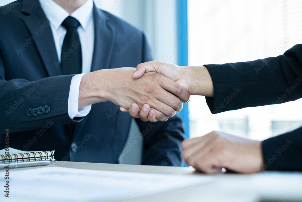 Shaking hand two business leaders talk about charts, financial graphs showing results are analyzing and calculating planning strategies, business success building processes