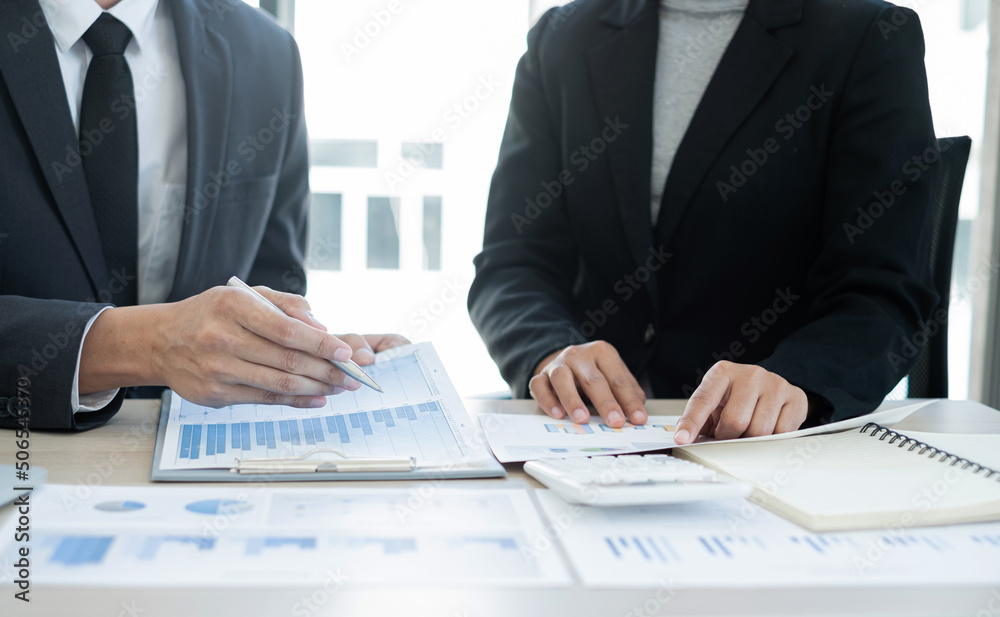 Two business leaders talk about charts, financial graphs showing results are analyzing and calculating planning strategies, business success building processes Two business leaders talk about charts, financial graphs showing results are analyzing and calculating planning strategies, business success building processes
