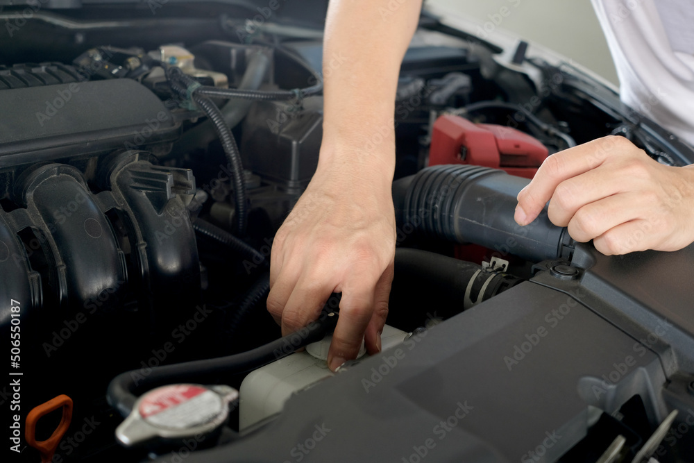 Car maintenance technician He is checking the auto engine, car inspection center.