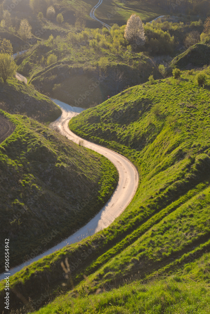 Poland, Grodzisko Stradów. Beautiful landscape, winding street, road. Countryside, outside the city. Fields and meadows.